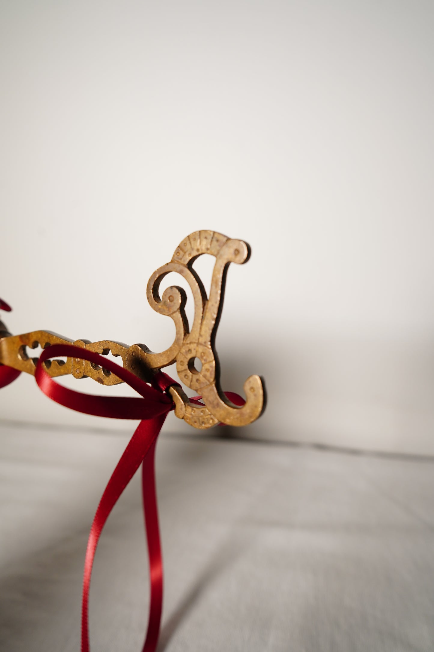 Pair of Ornate Brass French Curtain Rod Brackets with Scrollwork and Quatrefoil Piercing