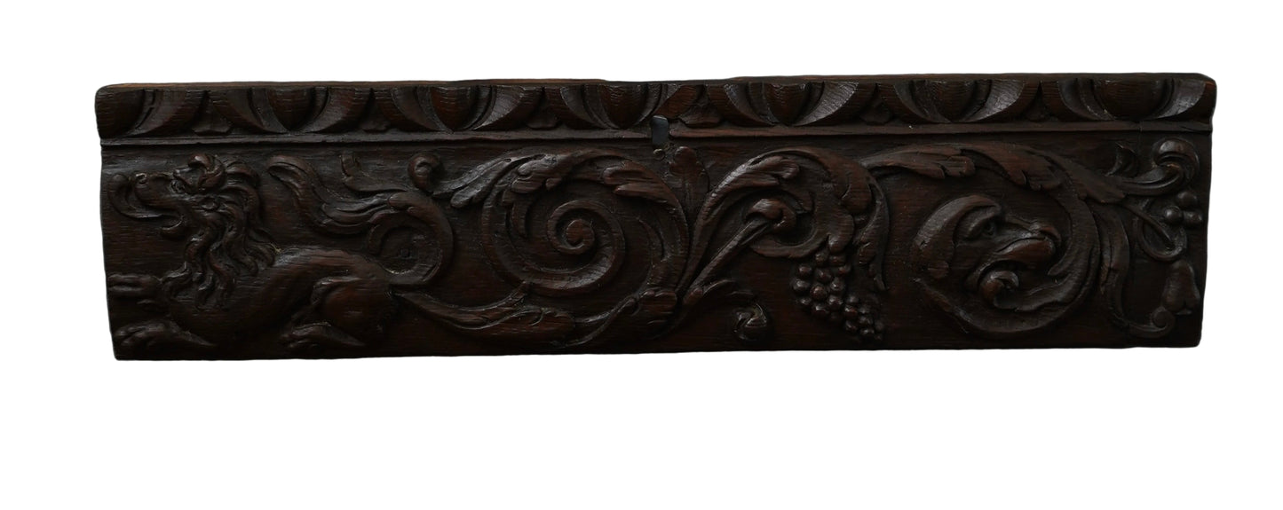 Decorative wooden panel with intricate carvings on a dark background